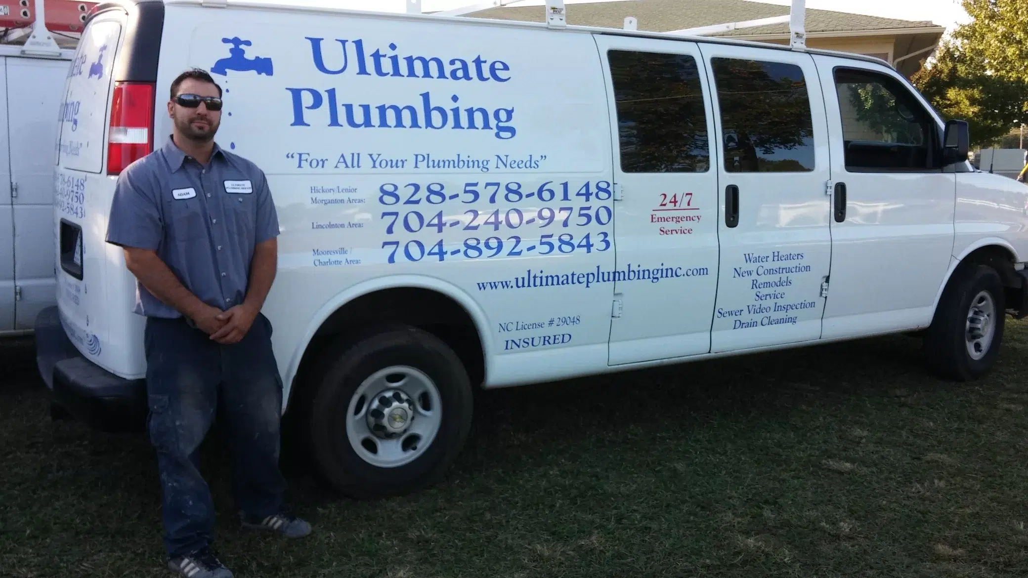 A technician in front of an Ultimate Plumbing service van